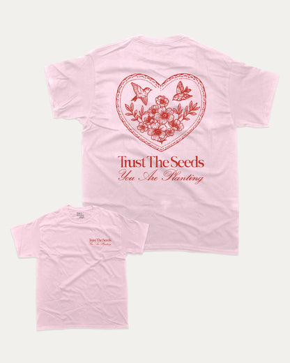 Trust The Seeds graphic t-shirt, Vintage Inspired Graphic T shirt, Retro Inspired Graphic T shirt, . A must-have funny tee, trending meme shirt, unique gift idea. Pink.