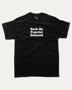 Back By Popular Demand graphic t-shirt, perfect for adults. A must-have funny back to school tee, trending meme shirt, unique gift idea. Black.