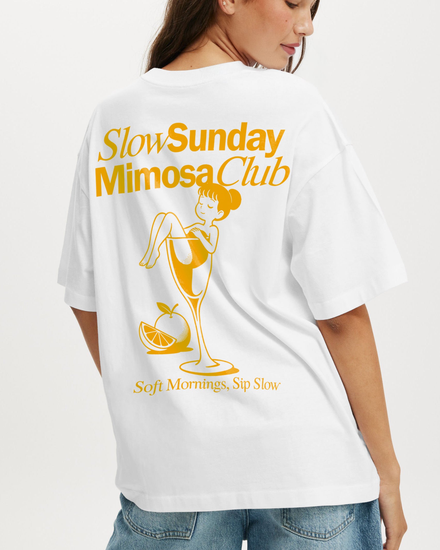 White t-shirt with 'Slow Sunday Mimosa Club' design on a plain background