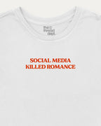 White t-shirt with red text 'SOCIAL MEDIA KILLED ROMANCE' and brand logo on a white background