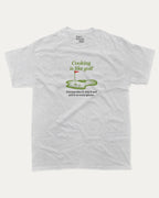 Cooking is like golf graphic tee with bold and humorous print, funny and trendy graphic. Perfect Gift for Golfers, Golf Graphic T shirt, Perfect for adults and gift-giving. Ash Grey shirt.