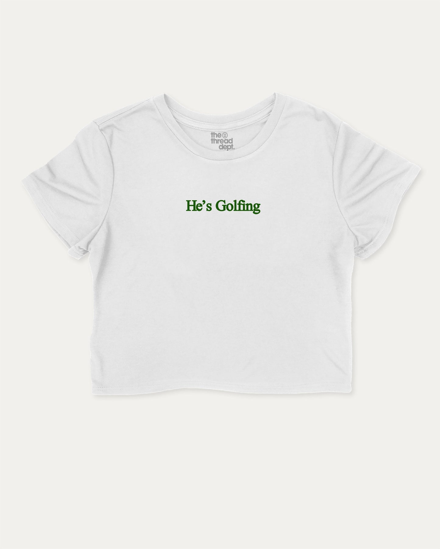 He's Golfing graphic crop tee with funny and trendy slogan print, perfect for women’s casual looks or layering. Perfect Gift for Golfers, Golf lovers Graphic cropped t shirt,   White crop t-shirt.