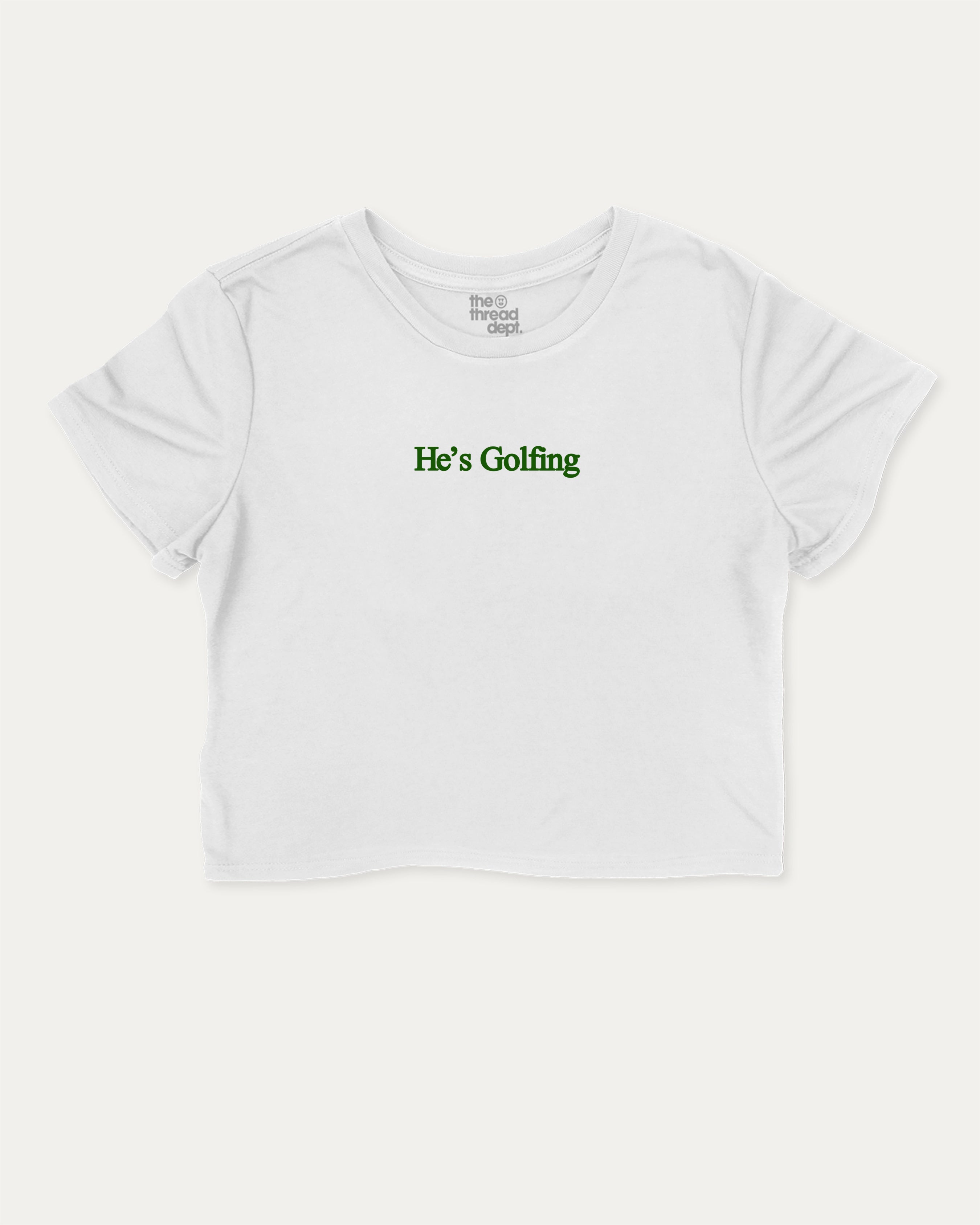 He's Golfing graphic crop tee with funny and trendy slogan print, perfect for women_ casual looks or layering. Perfect Gift for Golfers, Golf lovers Graphic cropped t shirt,   White crop t-shirt.