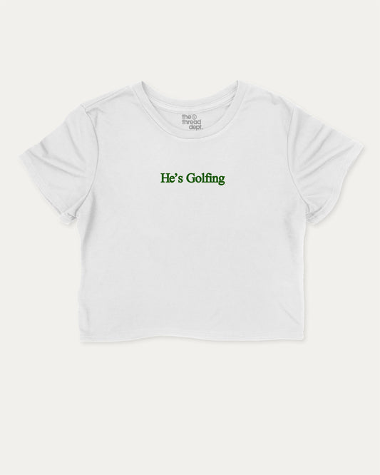 He's Golfing graphic crop tee with funny and trendy slogan print, perfect for women’s casual looks or layering. Perfect Gift for Golfers, Golf lovers Graphic cropped t shirt,   White crop t-shirt.