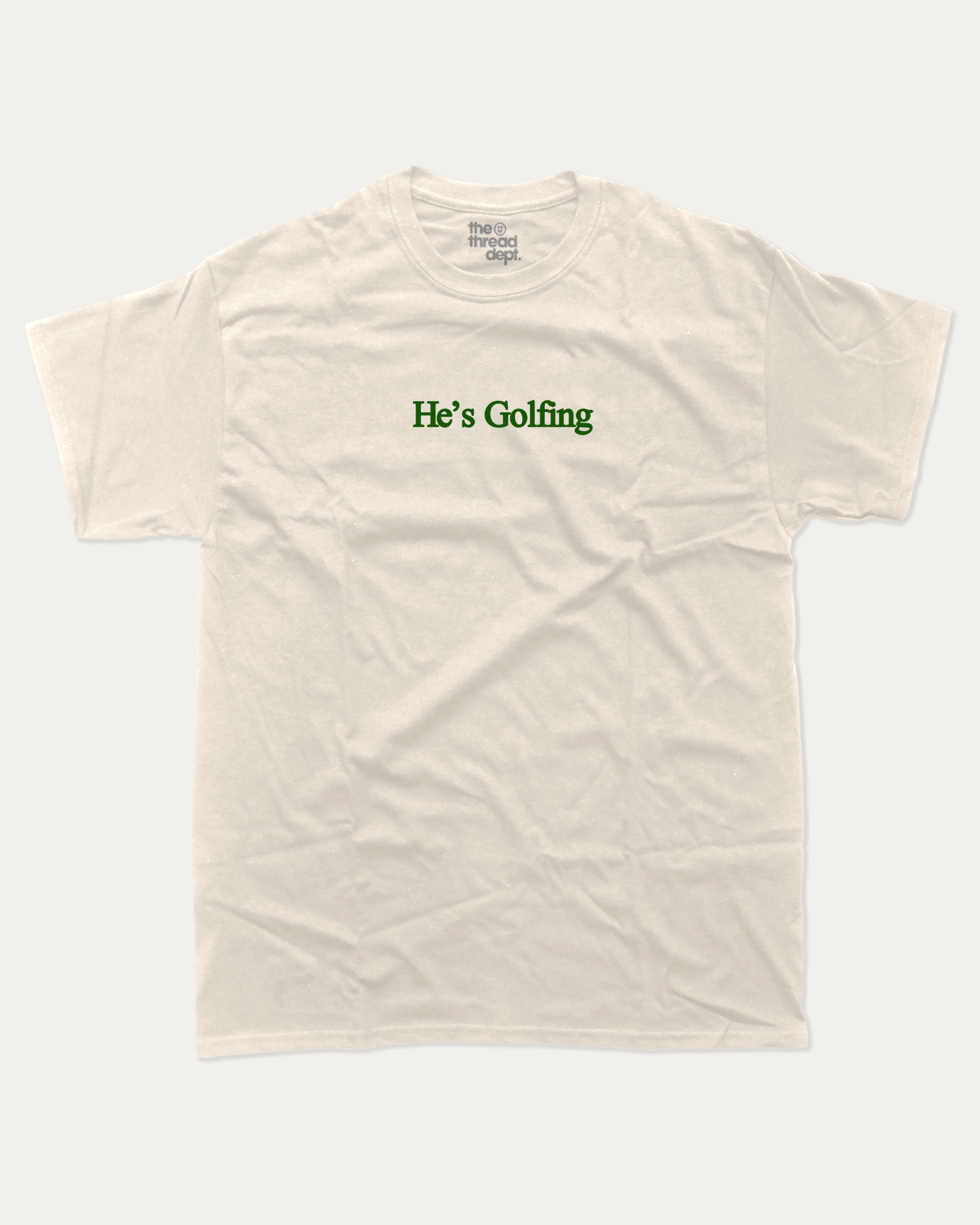 He's Golfing graphic tee with bold and humorous print, funny and trendy graphic. Perfect Gift for Golfers, Golf lovers Graphic t shirt,   Perfect for adults and gift-giving. Cream shirt.