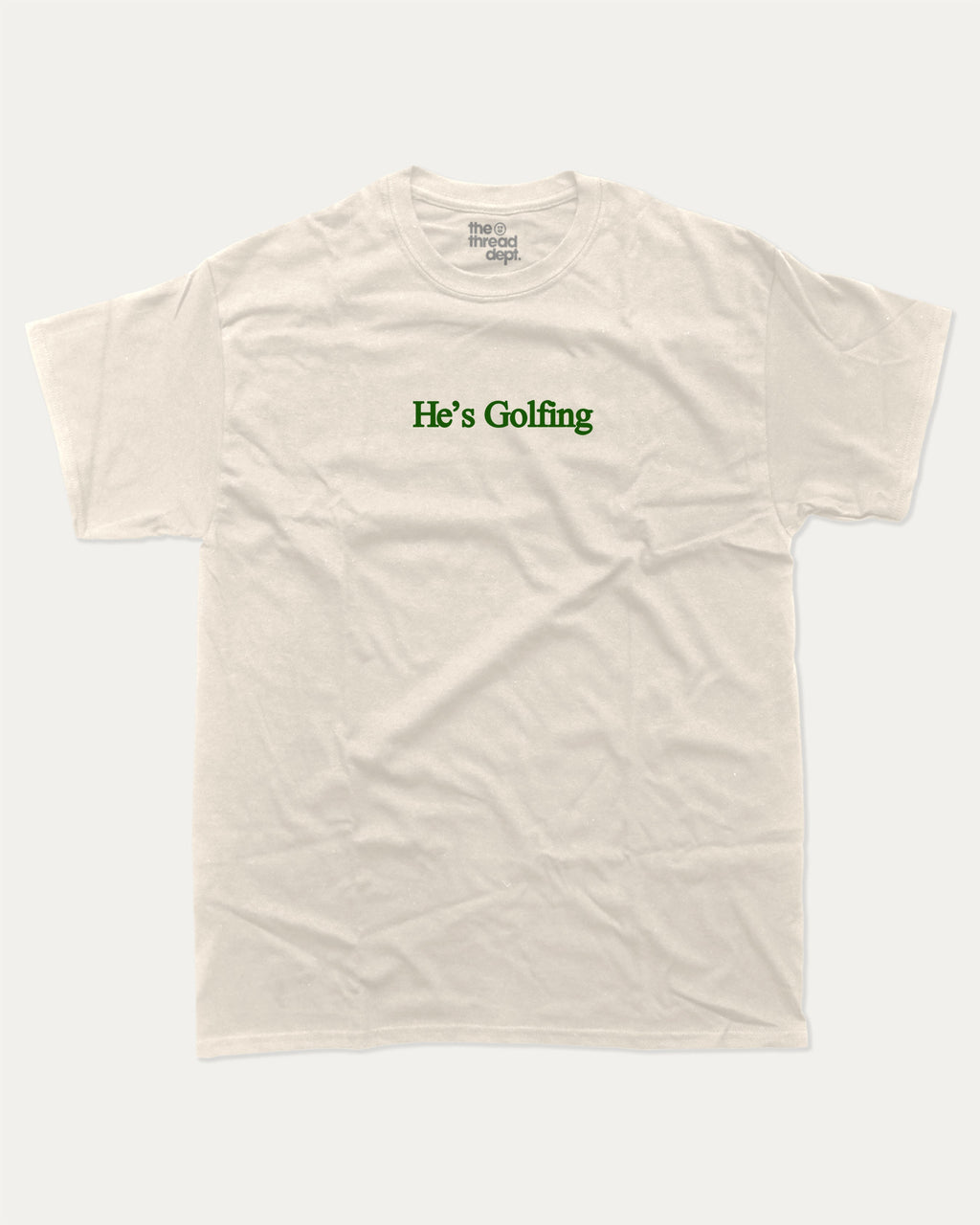 He's Golfing graphic tee with bold and humorous print, funny and trendy graphic. Perfect Gift for Golfers, Golf lovers Graphic t shirt,   Perfect for adults and gift-giving. Cream shirt.