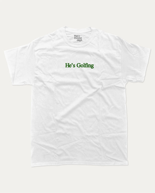 He's Golfing graphic tee with bold and humorous print, funny and trendy graphic. Perfect Gift for Golfers, Golf lovers Graphic t shirt,   Perfect for adults and gift-giving. White shirt.