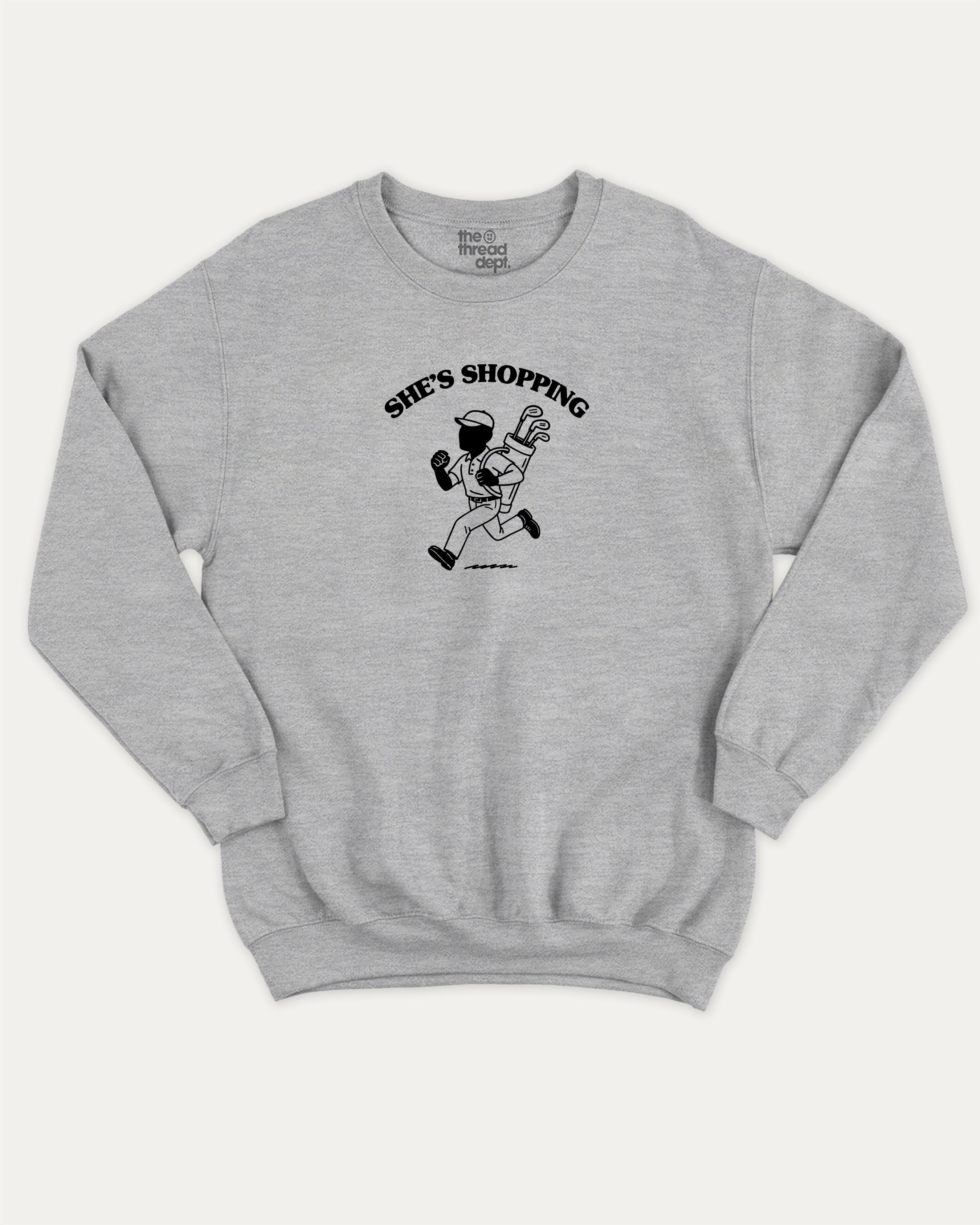 She's Shopping graphic sweatshirt with bold and humorous print, Golf Graphic T shirt, Perfect Gift for Golf Lover,  warm and cozy graphic for everyday wear. Perfect for adults and gift-giving. Heather Grey pullover.