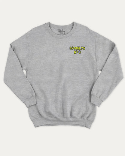 Brooklyn graphic sweatshirt with bold and humorous print, warm and cozy graphic for everyday wear. New York City Graphic Pull Over, State Graphic Pull Over Perfect for adults and gift-giving. Heather Grey pullover.