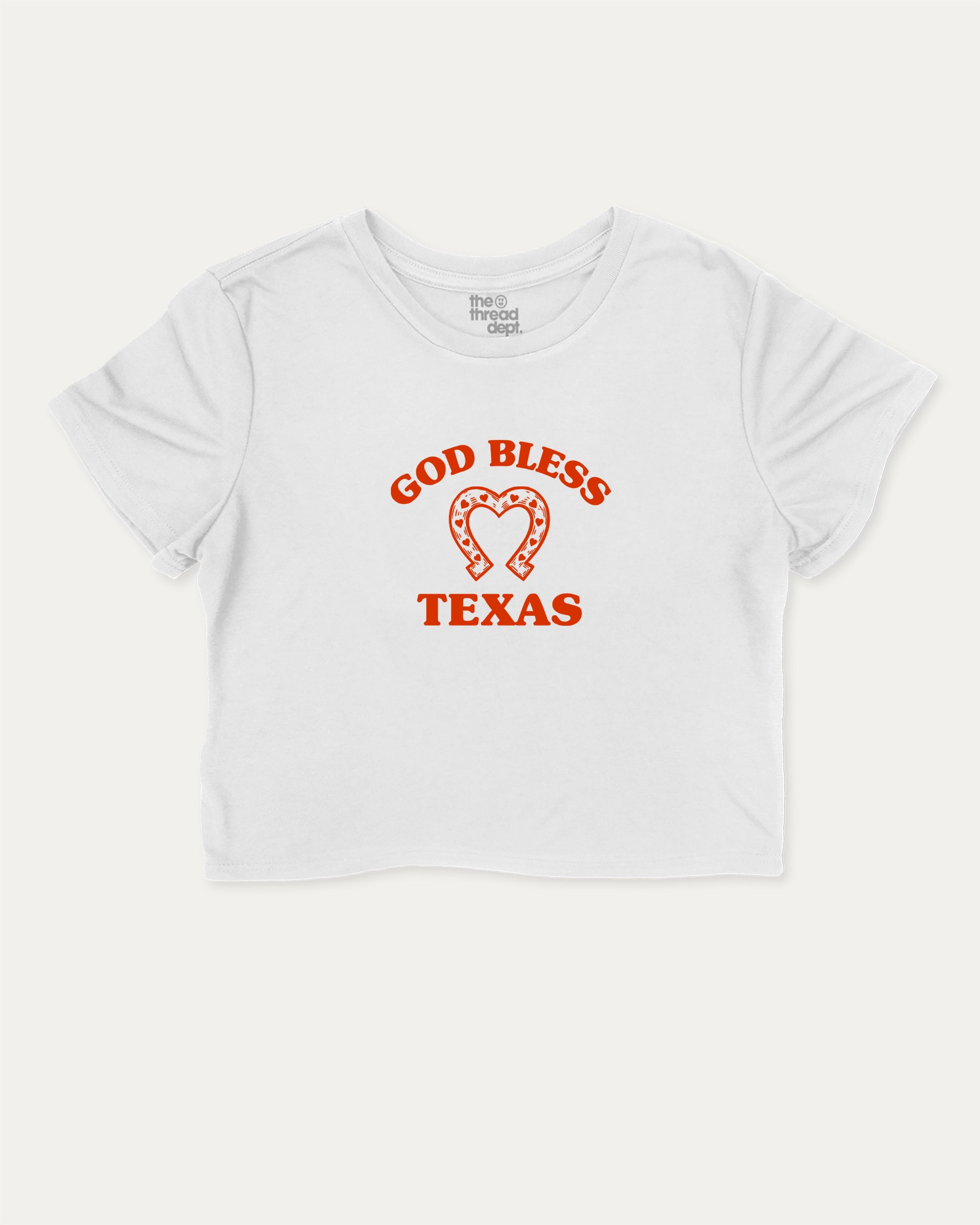 God Bless Taxas graphic crop tee with funny and trendy slogan print, perfect for women’s casual looks or layering. White crop t-shirt.