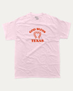 God Bless Taxas graphic tee with bold and humorous print, funny and trendy graphic. Perfect for adults and gift-giving. Pink shirt.