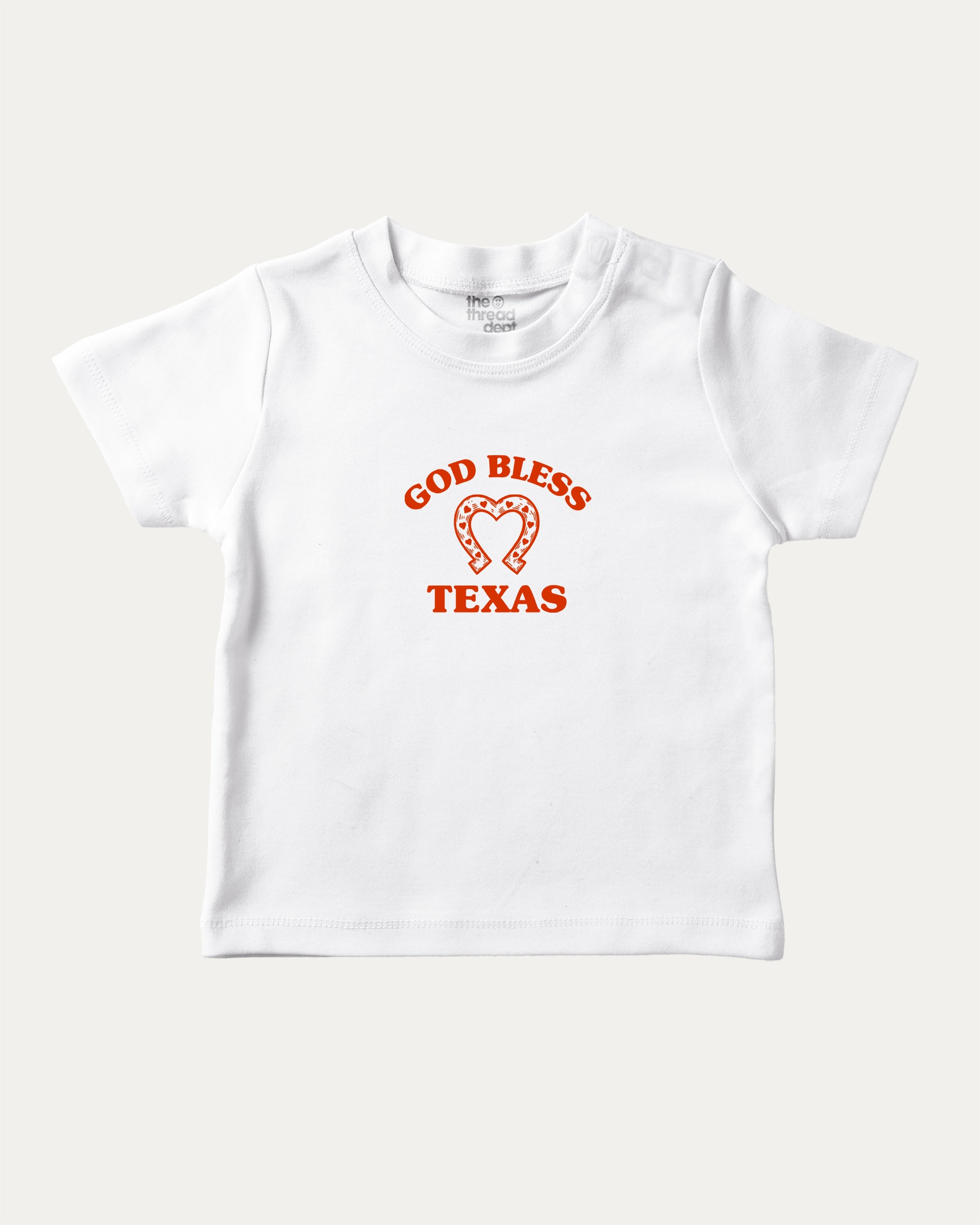 God Bless Taxas graphic tee with bold and humorous print, funny and trendy graphic. Perfect for adults and gift-giving. White shirt.