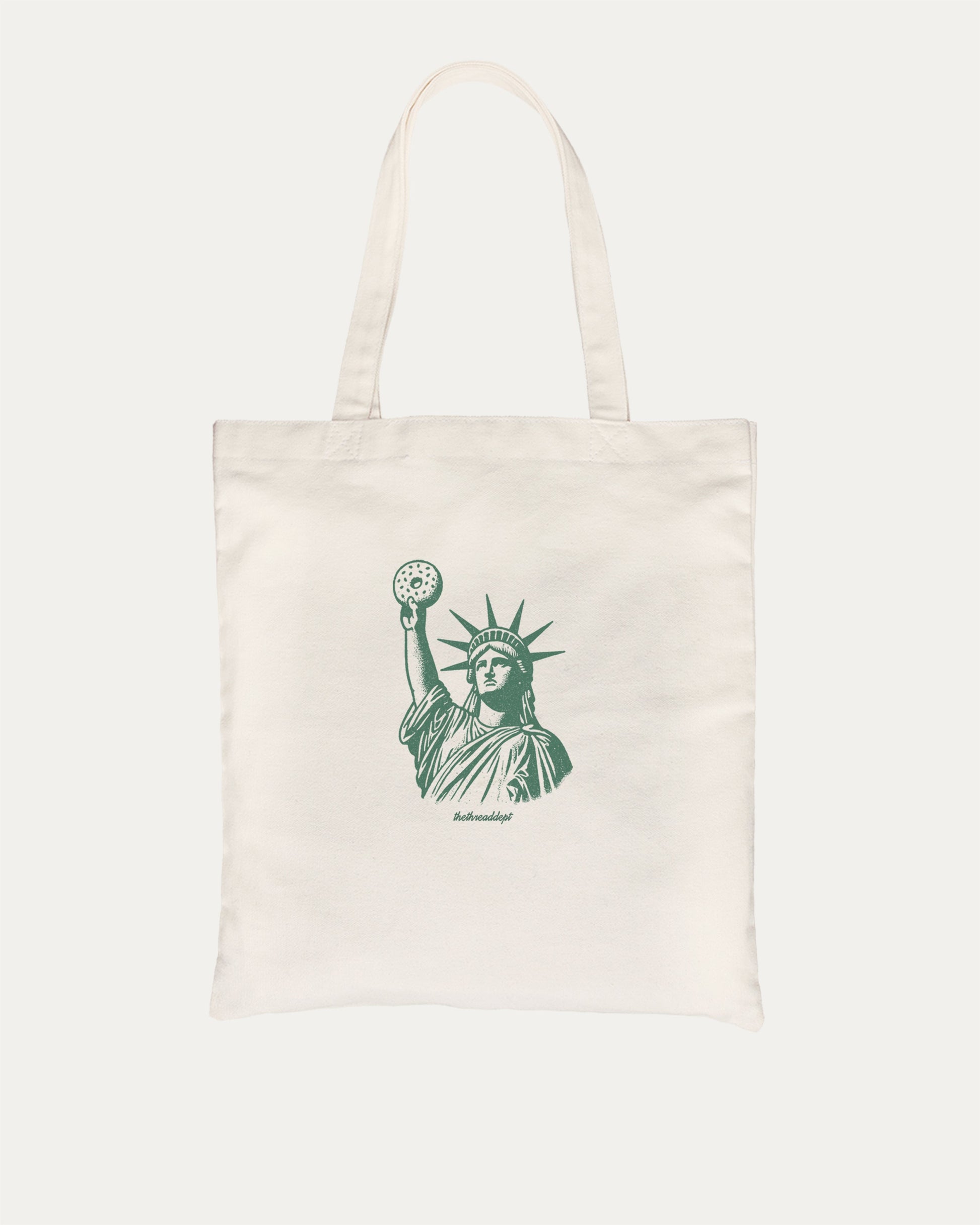 Statue of Liberty Bagle graphic tote bag with bold and funny print, reusable tote for school, errands, or gifting. Natural tote bag.
