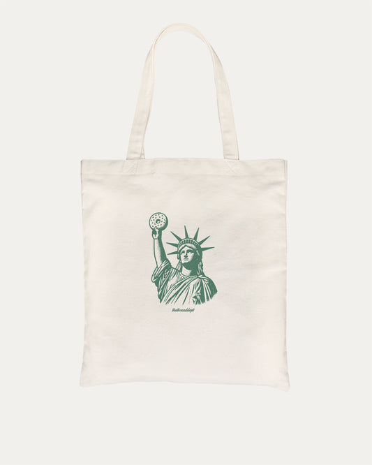 Statue of Liberty Bagle graphic tote bag with bold and funny print, reusable tote for school, errands, or gifting. Natural tote bag.