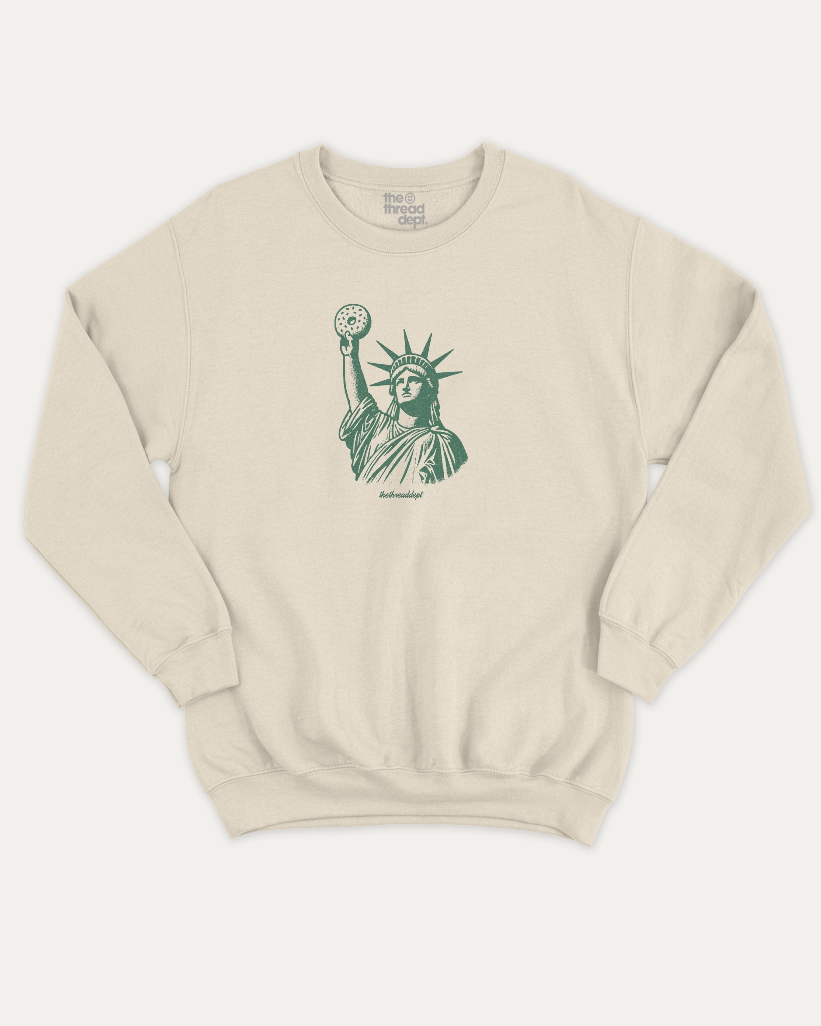 Statue of Liberty Bagle graphic sweatshirt with bagle and new york city print, warm and cozy graphic for everyday wear. Perfect for adults and gift-giving. Natural pullover.