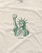 Beige t-shirt with green graphic of the Statue of Liberty holding a bagle.