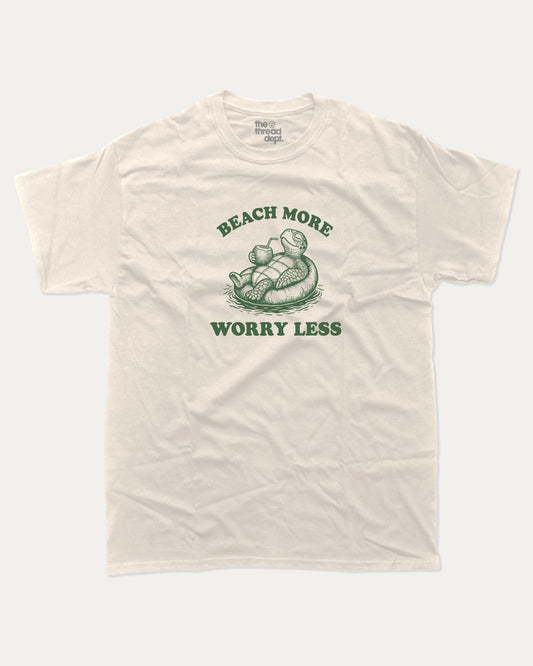 Beach More Worry Less graphic t-shirt, perfect for adults. A must-have funny summer tee, trending meme shirt, unique gift idea. Cream.