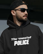 Man wearing a black hoodie with 'Thermostat POLICE' text, black cap, and sunglasses.