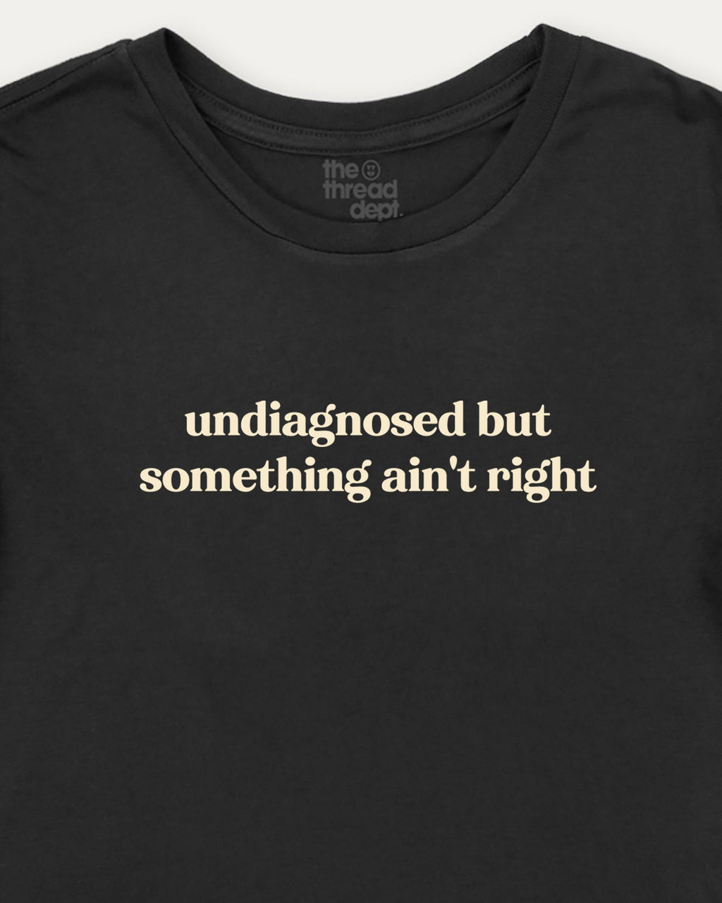 Black t-shirt with white text 'undiagnosed but something ain't right' on a white background