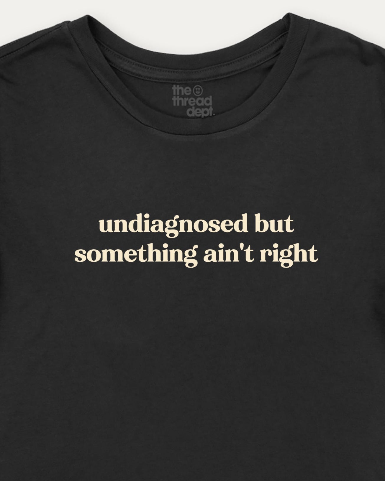 Black t-shirt with white text 'undiagnosed but something ain't right' on a white background