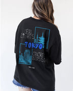 Black t-shirt with blue and tokyo graphics and text on a plain background